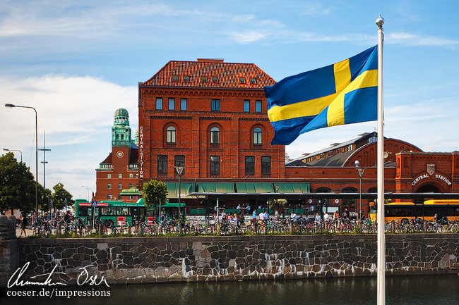 Eine schwedische Fahne vor dem Gebäude des Hauptbahnhofs in Malmö, Schweden.